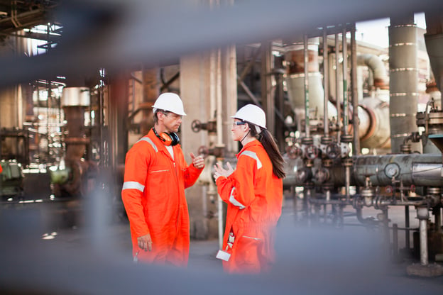 iStock-149319768-Workers_talking_at_oil_refinery_stock_photo