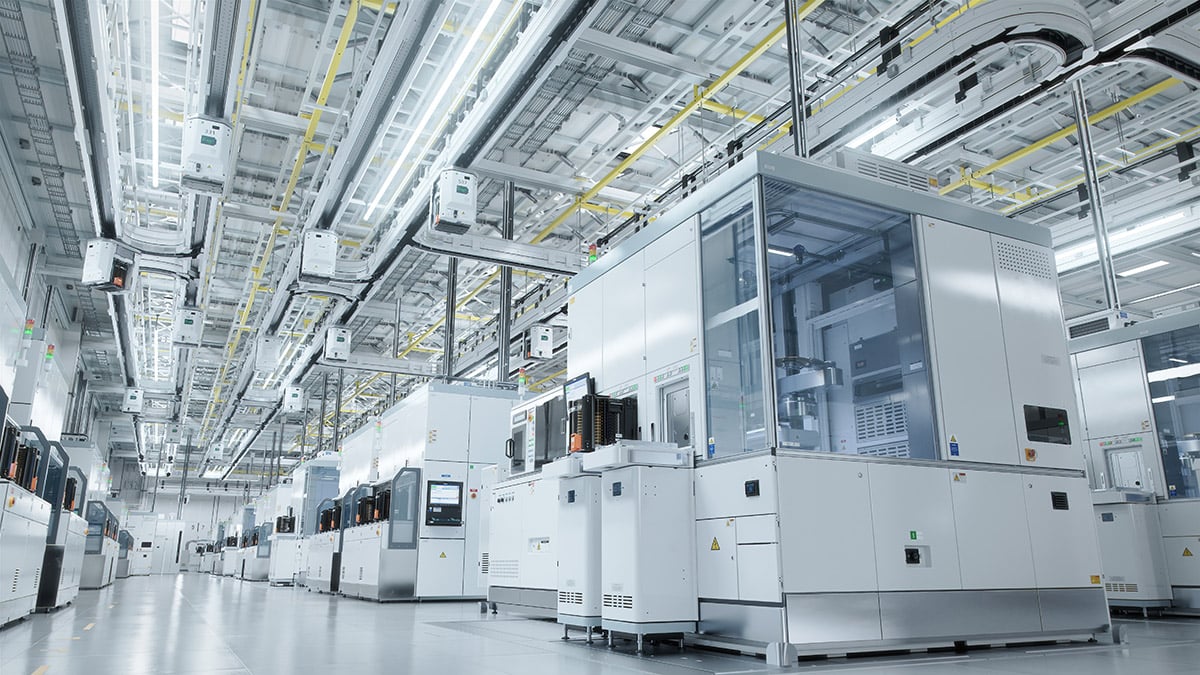 Advanced semiconductor fab equipment lined up in a semiconductor manufacturing facility
